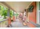 Charming front porch with cozy rocking chairs, a 'welcome' mat, and brick accents at 3864 Osceola St, Denver, CO 80212