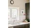 Kitchen sink and counter with modern fixtures, white backsplash, and a bright window at 3864 Osceola St, Denver, CO 80212