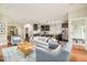 Spacious living room offers open layout with hardwood floors, and access to kitchen and entryway at 3864 Osceola St, Denver, CO 80212