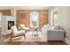 Stylish living room featuring an exposed brick wall, fireplace, and modern furniture at 3864 Osceola St, Denver, CO 80212