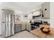 Galley kitchen with stainless steel appliances and wood countertops at 17286 E Ford Dr, Aurora, CO 80017