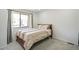 Bright bedroom features a large window and neutral decor at 7995 E Mississippi Ave # A4, Denver, CO 80247