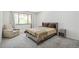 Comfortable bedroom with a cozy armchair, a plush bed, and a large bright window at 7995 E Mississippi Ave # A4, Denver, CO 80247