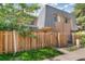 Charming home features a fenced yard and lush landscaping at 7995 E Mississippi Ave # A4, Denver, CO 80247
