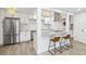 Stylish kitchen featuring white cabinetry, stainless appliances, and breakfast bar at 7995 E Mississippi Ave # A4, Denver, CO 80247