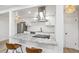 Modern kitchen features granite counters, stainless hood, and breakfast bar seating at 7995 E Mississippi Ave # A4, Denver, CO 80247