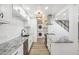 Bright kitchen with white cabinetry and stainless steel appliances and eat-in bar with granite countertops at 7995 E Mississippi Ave # A4, Denver, CO 80247