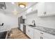 Bright kitchen with white cabinetry, granite countertops, and stainless steel appliances at 7995 E Mississippi Ave # A4, Denver, CO 80247
