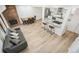 Open concept living room with wood floors, brick fireplace, sofa and a bar overlooking kitchen at 7995 E Mississippi Ave # A4, Denver, CO 80247