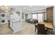 Open-concept living area boasts modern kitchen, staircase, and sliding glass doors at 7995 E Mississippi Ave # A4, Denver, CO 80247