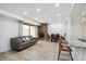 Bright living room featuring brick fireplace, recessed lighting, and breakfast bar at 7995 E Mississippi Ave # A4, Denver, CO 80247