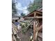 View of a backyard with an animal shelter, sheds, and dogs at 1900 Quebec St, Denver, CO 80220
