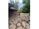 Patio area leading to a backyard with various items and greenery at 1900 Quebec St, Denver, CO 80220