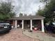 Charming brick home featuring a covered front porch with white pillars and a cozy, inviting entrance at 1900 Quebec St, Denver, CO 80220