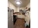 Compact kitchen featuring traditional cabinets, standard appliances, and a layout ready for updates at 1900 Quebec St, Denver, CO 80220