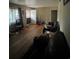 Cozy living room featuring hardwood floors, front window, and front door access at 1900 Quebec St, Denver, CO 80220