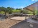 Backyard stone patio includes beautiful water feature and well maintained stone and grass at 14418 W Bayaud Ave, Golden, CO 80401