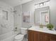 Bathroom featuring a marble shower and wood vanity at 14418 W Bayaud Ave, Golden, CO 80401