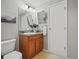 Neutral bathroom features vanity with wood cabinets, stone countertop, and modern lighting at 14418 W Bayaud Ave, Golden, CO 80401
