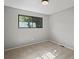 Empty bedroom with large window showing mature trees at 14418 W Bayaud Ave, Golden, CO 80401