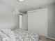 Bedroom featuring a double closet with sliding doors and view to hallway at 14418 W Bayaud Ave, Golden, CO 80401