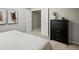 Bedroom featuring a chest of drawers and open closet for easy access at 14418 W Bayaud Ave, Golden, CO 80401