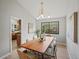 Bright dining room features a large window and a modern light fixture at 14418 W Bayaud Ave, Golden, CO 80401