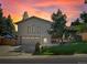 Charming brick home with well-manicured lawn and mature trees, perfect for Gathering living at 14418 W Bayaud Ave, Golden, CO 80401