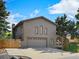 Charming brick home with a spacious driveway and lush greenery, ideal for Gathering comfort at 14418 W Bayaud Ave, Golden, CO 80401