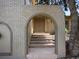 Inviting front entrance with arched brickway and steps leading to a welcoming double door at 14418 W Bayaud Ave, Golden, CO 80401