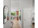 Bright hallway with views into the kitchen and light wood flooring, creating a modern ambiance at 14418 W Bayaud Ave, Golden, CO 80401
