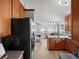 Kitchen with wood cabinets, stainless appliances, view into the living room at 14418 W Bayaud Ave, Golden, CO 80401