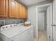 Bright laundry room features wood cabinets and a modern washer and dryer at 14418 W Bayaud Ave, Golden, CO 80401