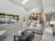Bright living room with view to backyard waterfall and well-lit kitchen at 14418 W Bayaud Ave, Golden, CO 80401
