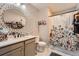 Stylish bathroom featuring modern vanity, updated fixtures, and a shower with floral curtain at 1831 S Dunkirk St # 103, Aurora, CO 80017
