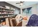 Unique bedroom featuring tent play area, comfy chair, and modern open shelving at 1831 S Dunkirk St # 103, Aurora, CO 80017