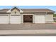 Open community garage area with white doors at 1831 S Dunkirk St # 103, Aurora, CO 80017