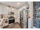 Well-appointed kitchen featuring stainless steel appliances, modern countertops and stylish cabinets at 1831 S Dunkirk St # 103, Aurora, CO 80017