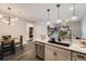 Well-lit kitchen featuring modern countertops, stainless steel appliances and stylish overhead lighting at 1831 S Dunkirk St # 103, Aurora, CO 80017