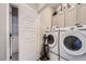 Efficient laundry room features modern washer and dryer, plus upper cabinets for storage at 1831 S Dunkirk St # 103, Aurora, CO 80017