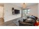 Comfortable living space featuring a sofa, entertainment center, and access to the balcony at 1831 S Dunkirk St # 103, Aurora, CO 80017