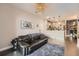Inviting living room with a modern light fixture, a comfortable sofa, and an open layout at 1831 S Dunkirk St # 103, Aurora, CO 80017