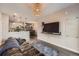 Open-concept living space with modern lighting, comfortable seating, and an adjacent kitchen at 1831 S Dunkirk St # 103, Aurora, CO 80017
