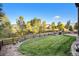 Landscaped backyard with grassy area and wooden fence at 6918 S Riverwood Way, Aurora, CO 80016