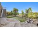 Landscaped backyard with fire pit and stairs leading to upper level at 6918 S Riverwood Way, Aurora, CO 80016