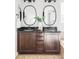 Elegant bathroom with double vanity and dark brown cabinets at 6918 S Riverwood Way, Aurora, CO 80016