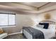 Bedroom with metal bed frame and neutral colored bedding at 6918 S Riverwood Way, Aurora, CO 80016