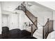 Elegant entryway with dark hardwood floors and a wooden staircase at 6918 S Riverwood Way, Aurora, CO 80016