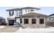 Two-story home with brick and siding, gray garage door, and balcony at 6918 S Riverwood Way, Aurora, CO 80016