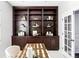 Bright home office with built-in shelving and French doors at 6918 S Riverwood Way, Aurora, CO 80016